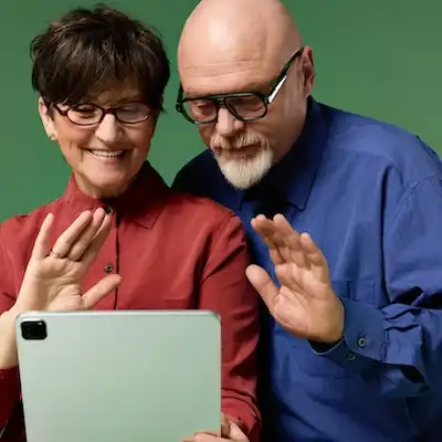 older people connecting with loved ones on a digital tablet