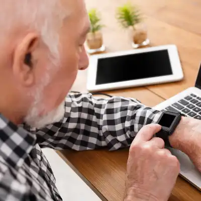 older man using smartwatch